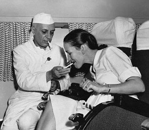 Nehru lighting a cigarette for the then British high commissioner's wife