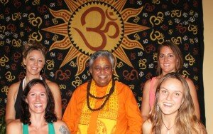 Yoga teachers in a yoga studio in Nevada with Rajan Zed (middle). In the background is “Om”, sacred symbol of Hinduism.