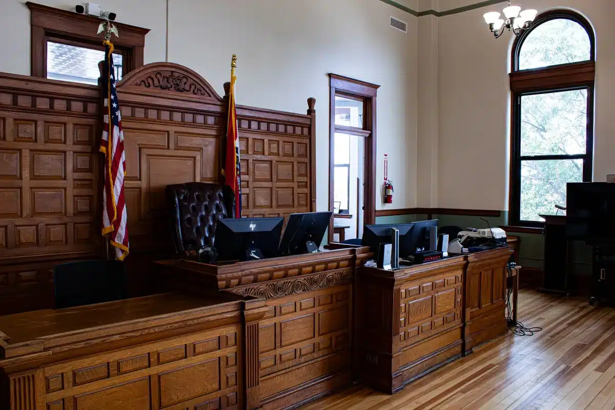 A courtroom interior with judges presiding over a hearing