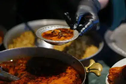 Steaming bowls of warm soup with root vegetables and spices on a winter table