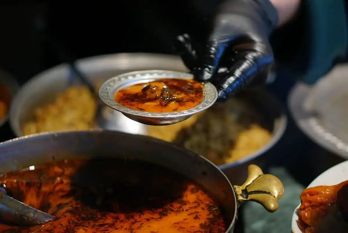 Steaming bowls of warm soup with root vegetables and spices on a winter table