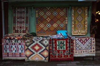 Handwoven fabrics and traditional crafts displayed at an artisan fair in a heritage setting