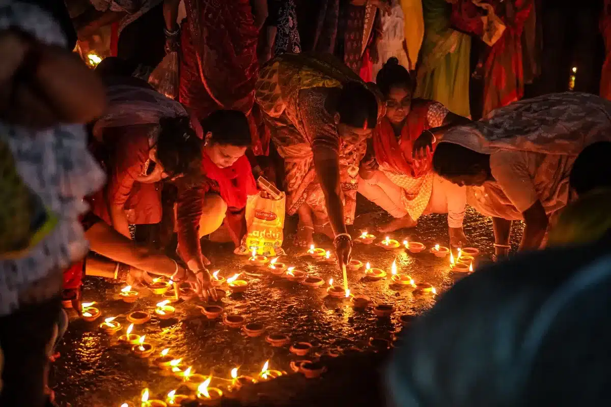 Community celebrating Diwali with lights and shared festivities across religious backgrounds