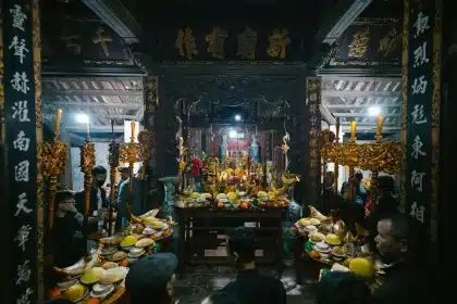 Woman participating respectfully in a Hindu temple festival with colorful flowers and ritual offerings