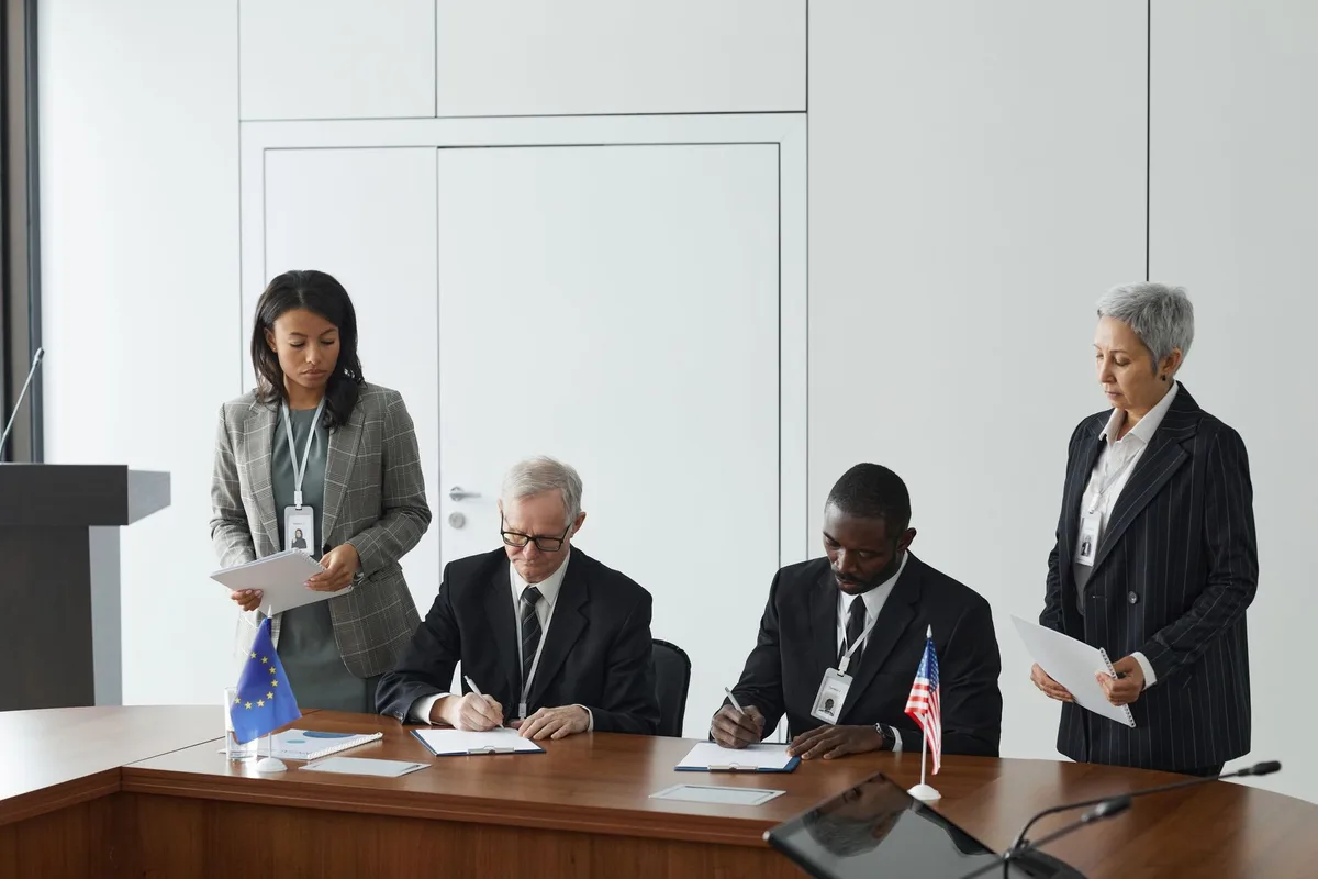 Diverse group of professionals in formal discussion at a global policy conference table
