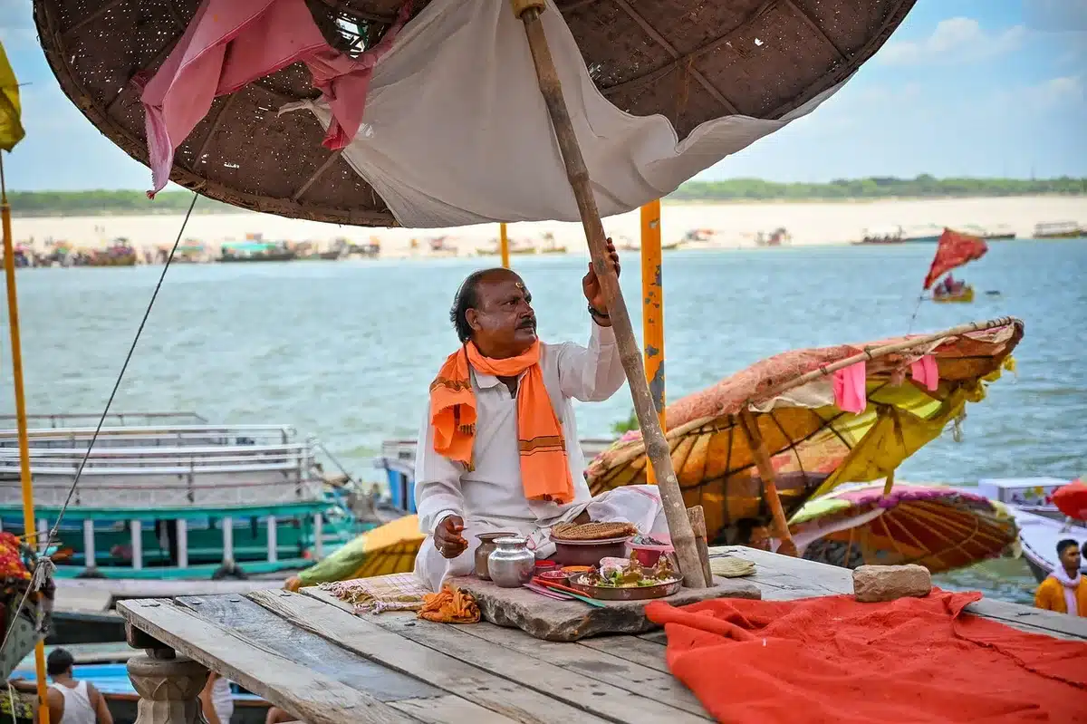 Evening Ganga aarti ceremony at Varanasi with lamps and devotees by the river