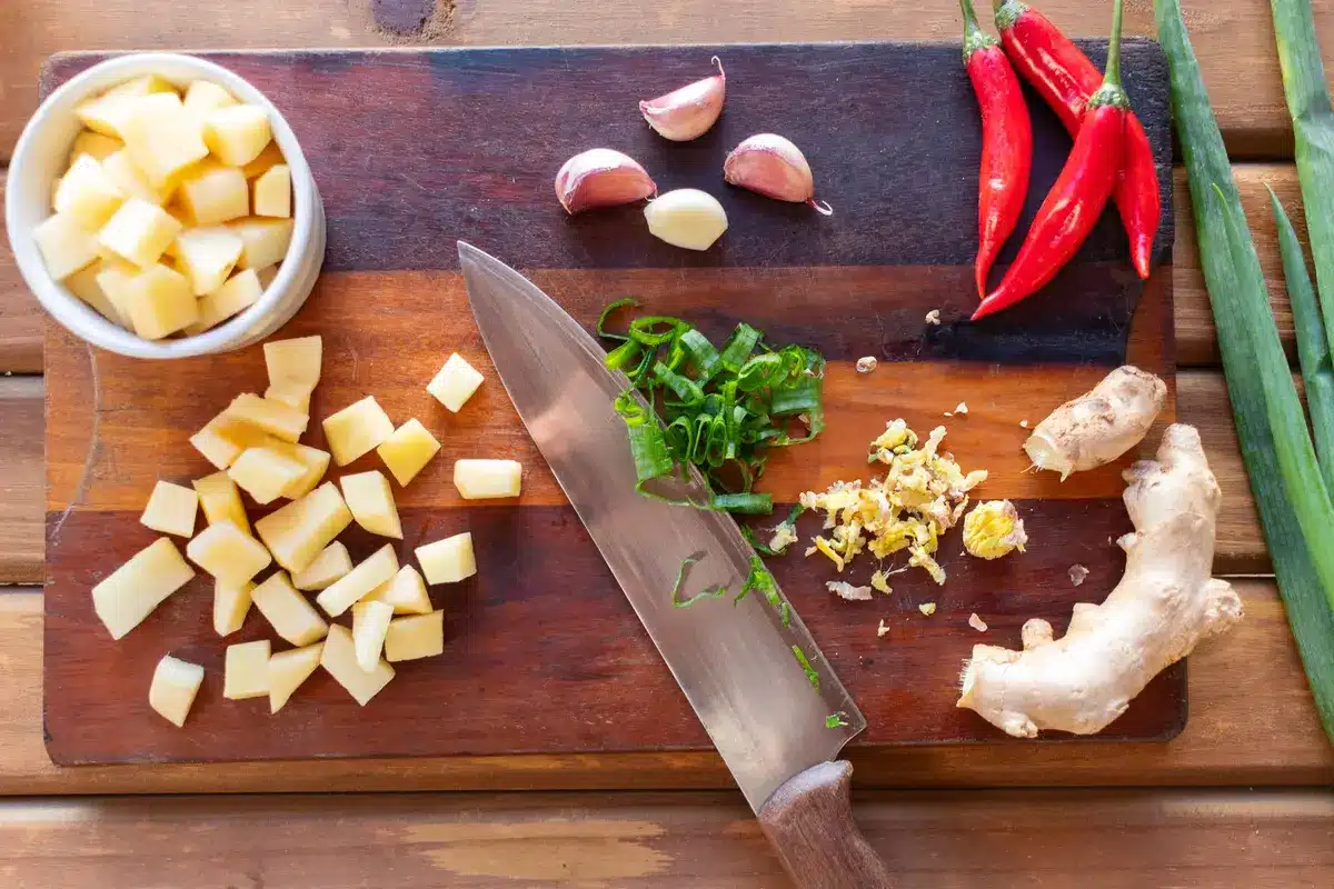 Fresh diced sweet potato, warming spices, and dates arranged on a counter ready for blending.