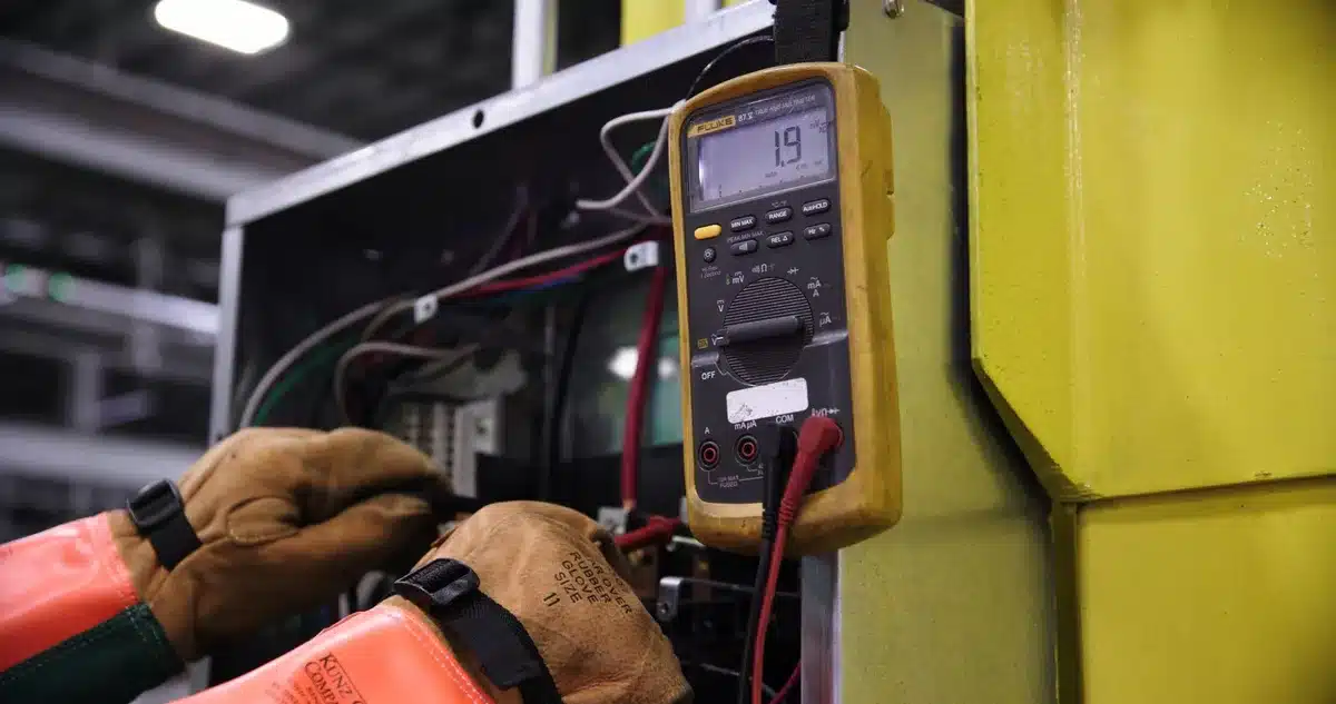 Fire safety inspector examining electrical systems and emergency exits in a hotel corridor