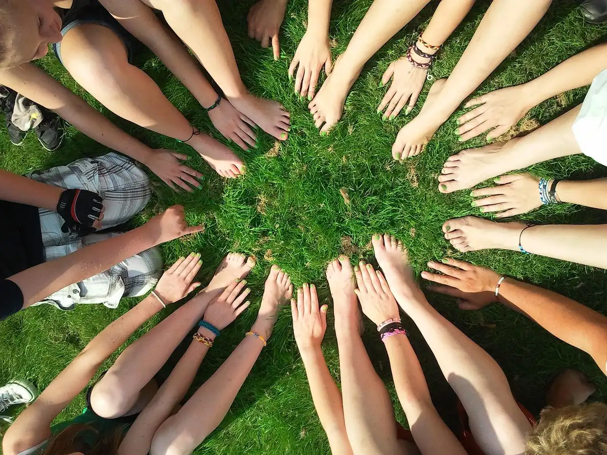 Diverse group of people sitting together in a circle during a communal chanting session