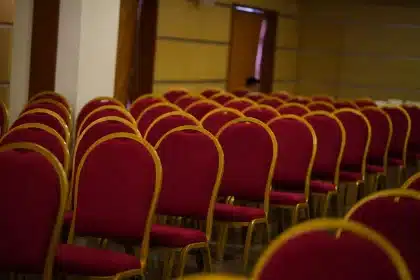 Delegates seated in a large convention hall during an international hospitality and tourism conference