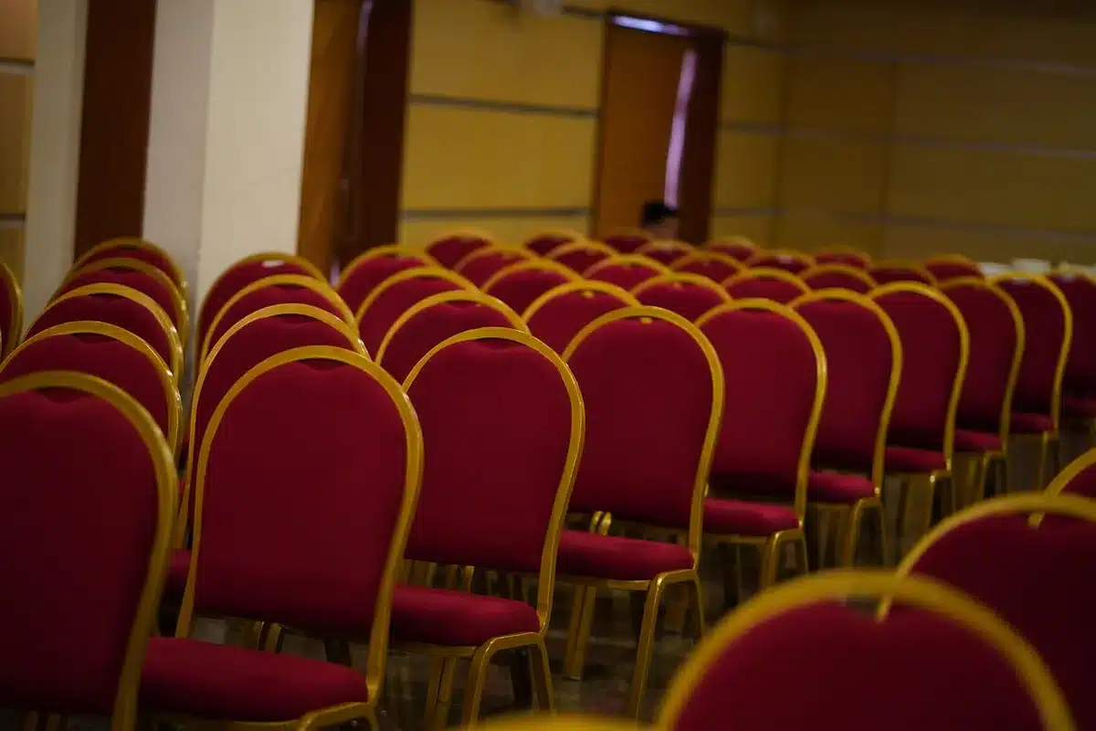 Delegates seated in a large convention hall during an international hospitality and tourism conference