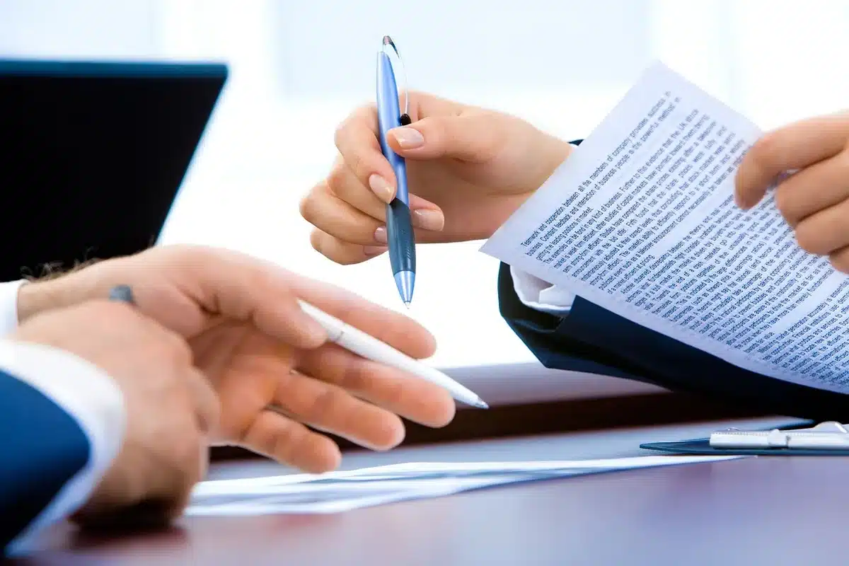 Stacks of legal documents and court summons papers representing judicial proceedings