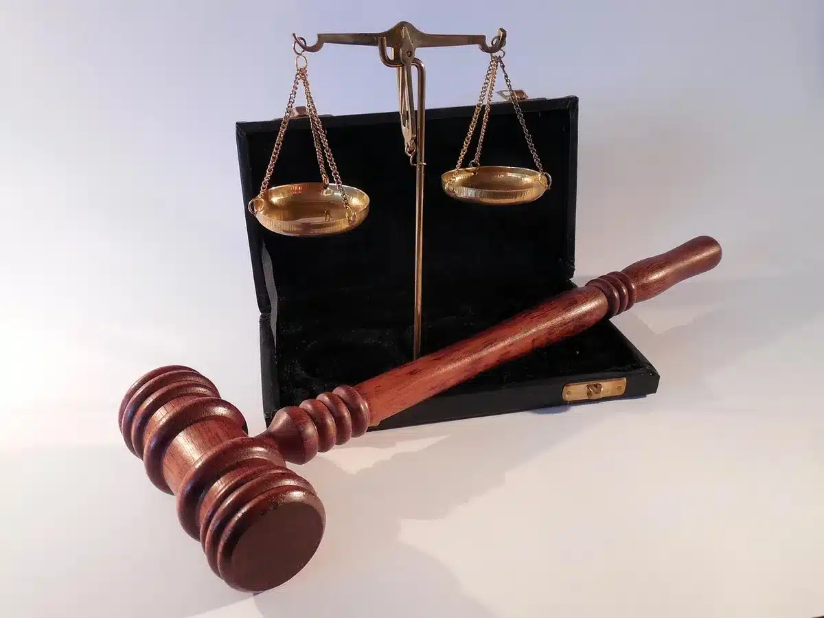 Court papers and a gavel beside rural land documents