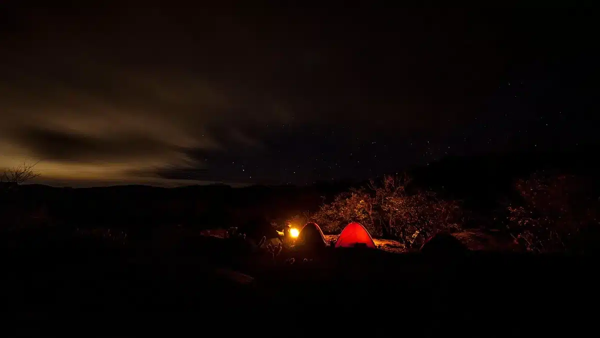 Rows of makeshift tents at a crowded refugee camp near a border