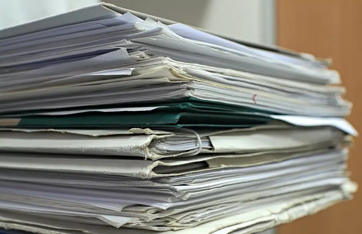 Volunteers organizing archival documents and photographs related to 1971