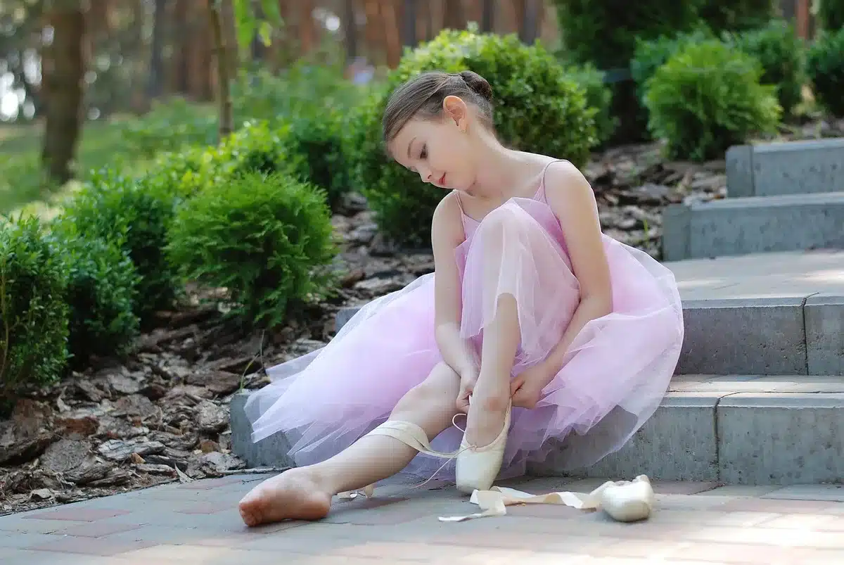 Young dancer poised in classical Bharatanatyam pose on stage
