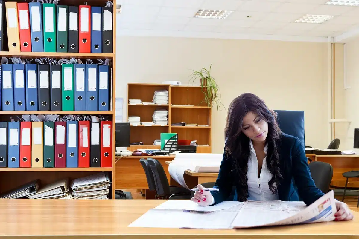 Police officer filing paperwork inside a station