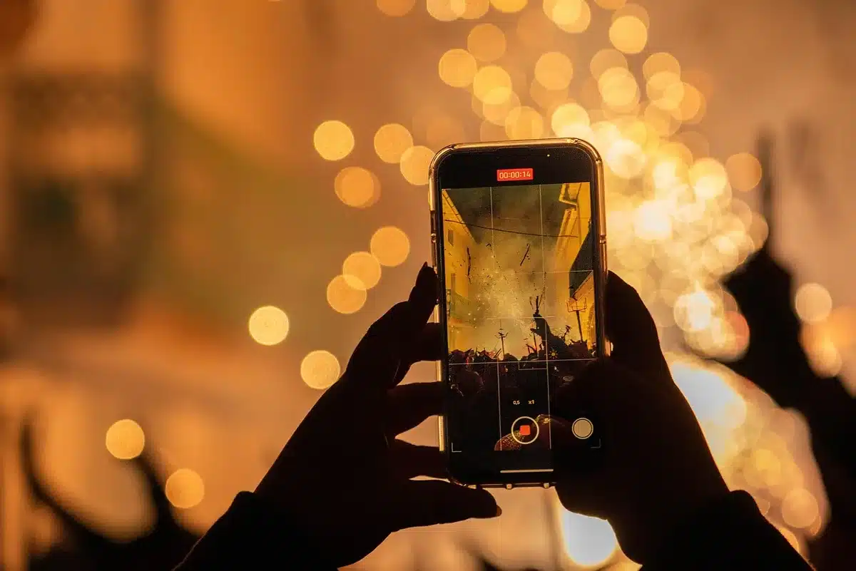 A reporter recording a meeting on a smartphone