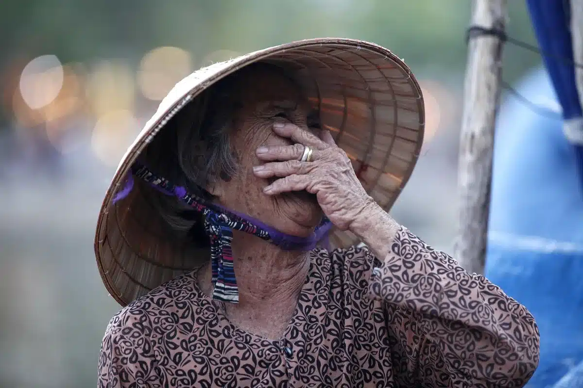 A caregiver's hands supporting an elderly person to illustrate care work and responsibility