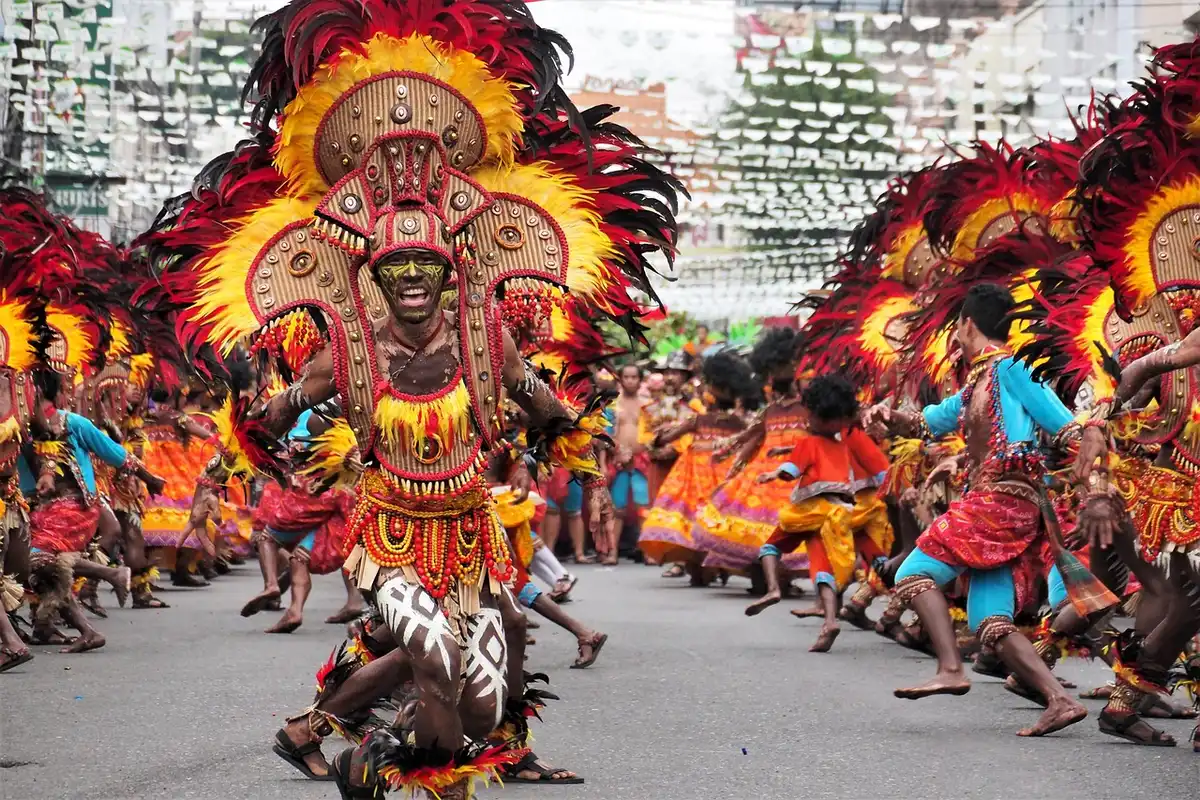 Anonymous procession moving through a city street during a festival