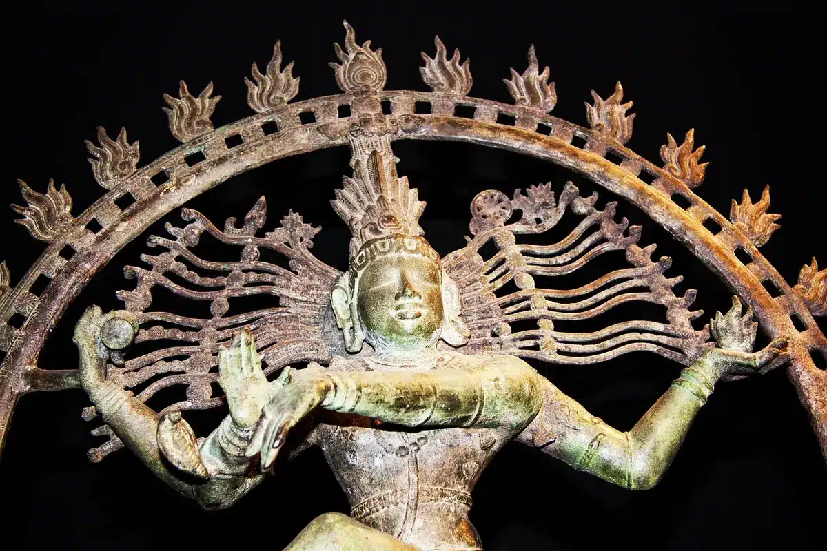 Bronze Nataraja statue showing Shiva's cosmic dance in temple setting