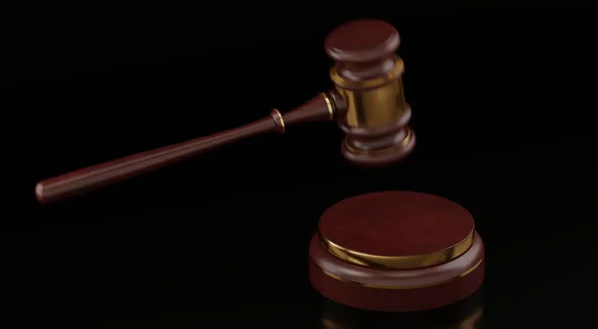 Scales of justice and gavel in a courthouse corridor
