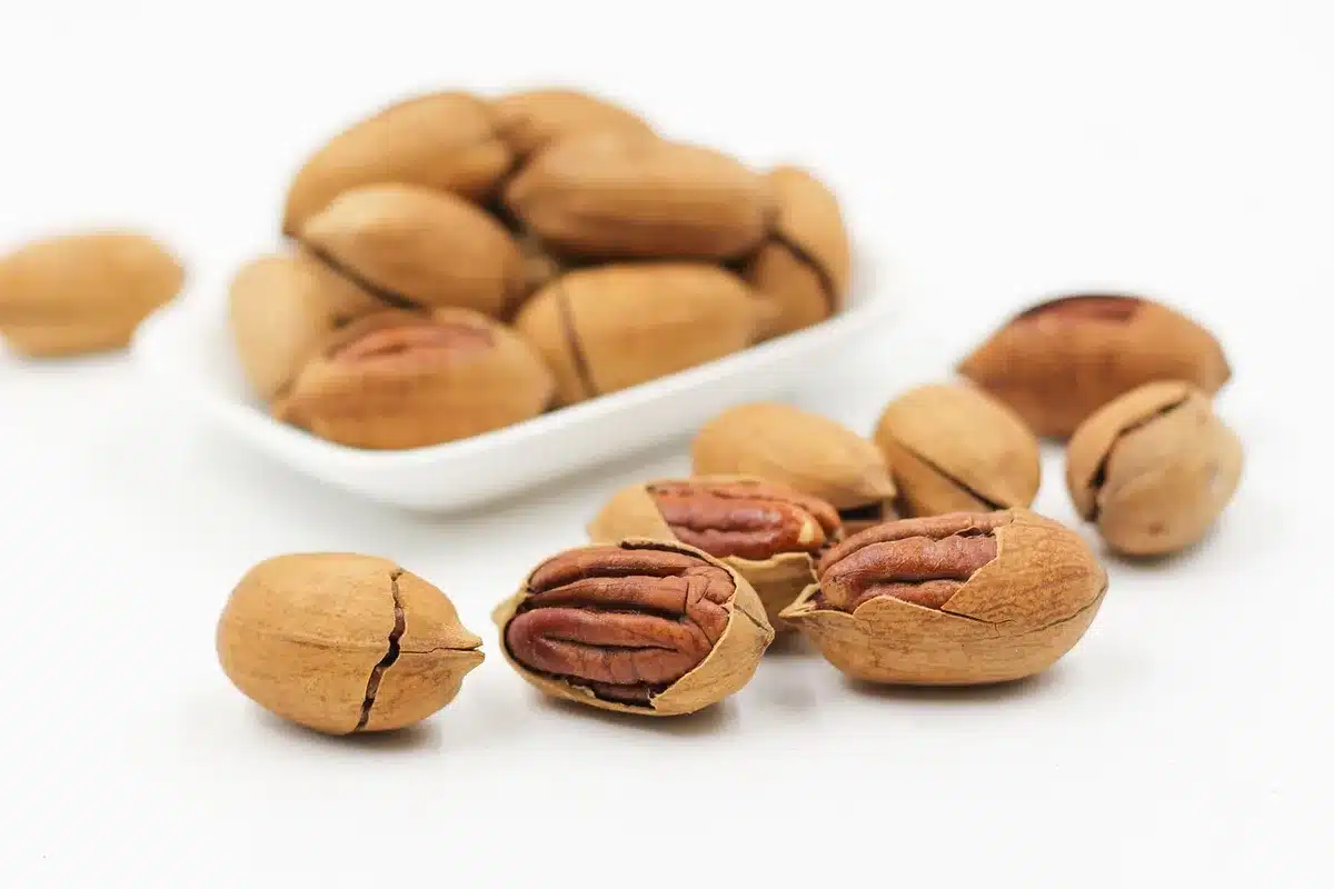 Nuts, banana and water bottle arranged as light fasting snacks
