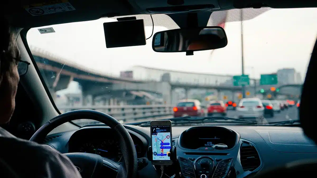 Driver with hands on head beside steering wheel, showing commute stress