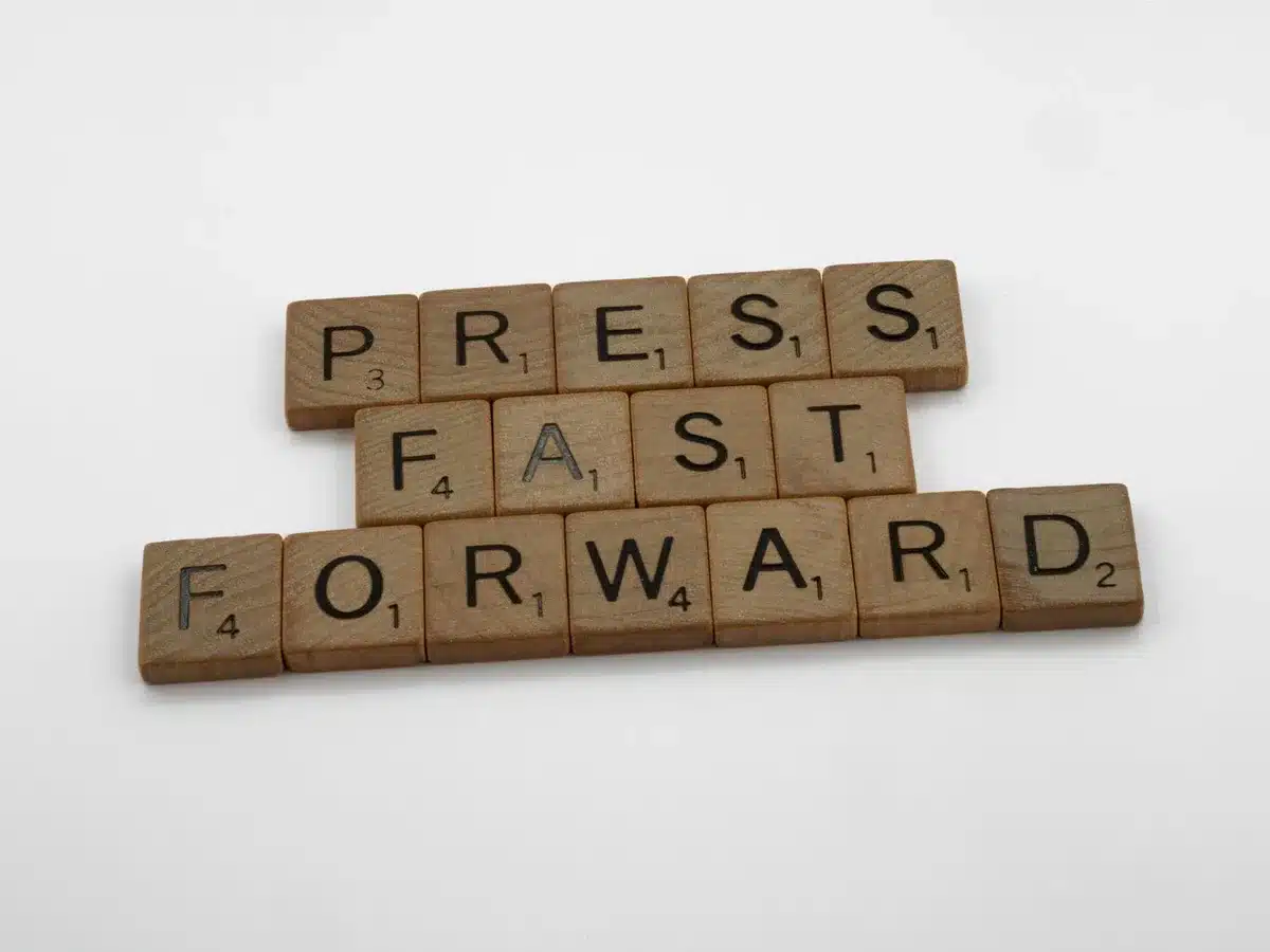 A blurred company press release on a screen with someone pointing at it
