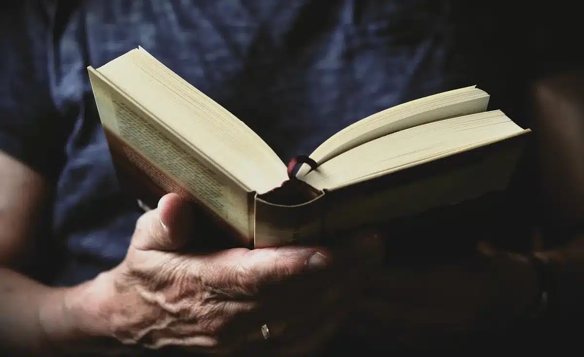 Stack of religious books and a simple note indicating training background