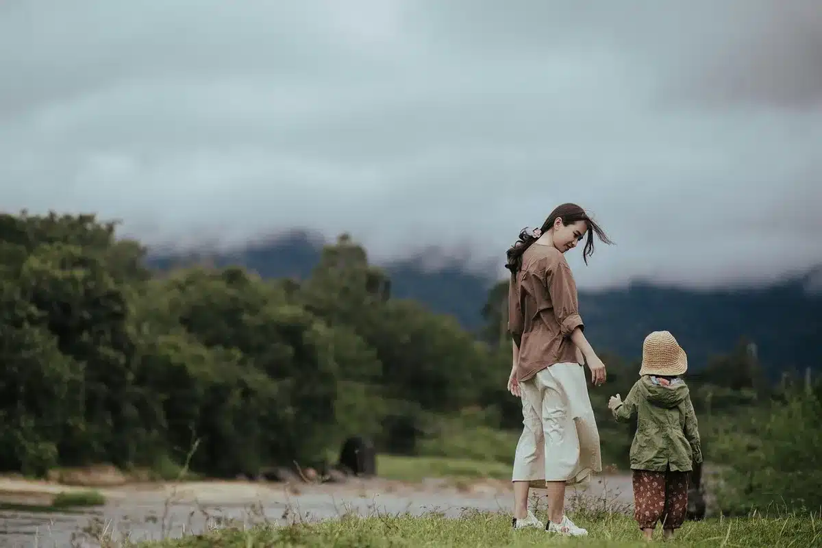 Parents dropping a child at a daycare centre illustrating childcare pressures